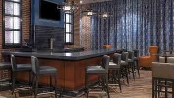 A bar area with a central island, bar stools, and a seating area with chairs and tables.