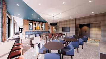 A modern lounge area with seating arrangements, a brick accent wall, and a large screen.