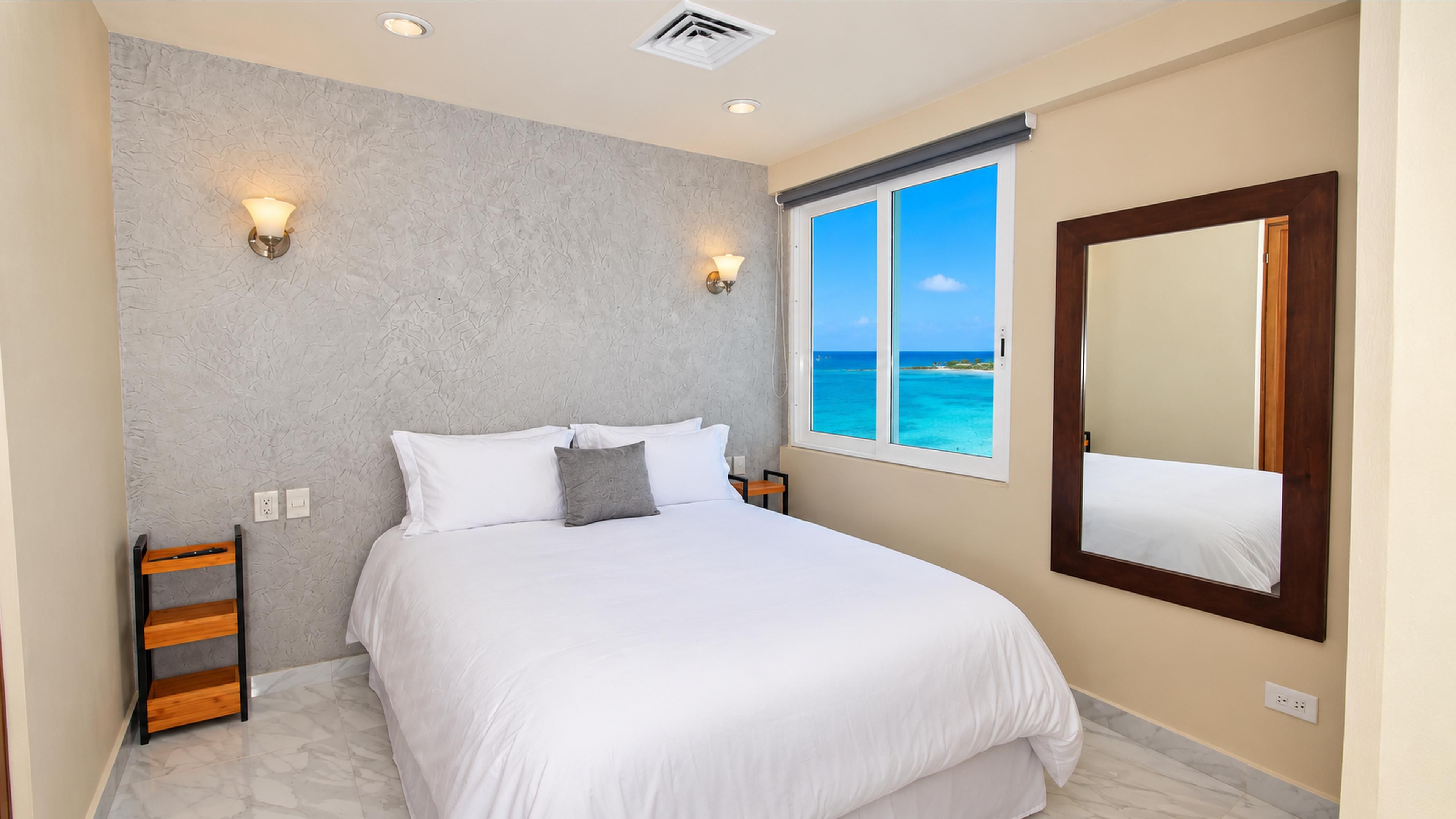Bedroom 3 offers a queen bed and Caribbean Sea views at Penthouse 3704.