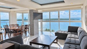 Open living and dining areas framed by panoramic Nichupté Lagoon views at Penthouse 3704.