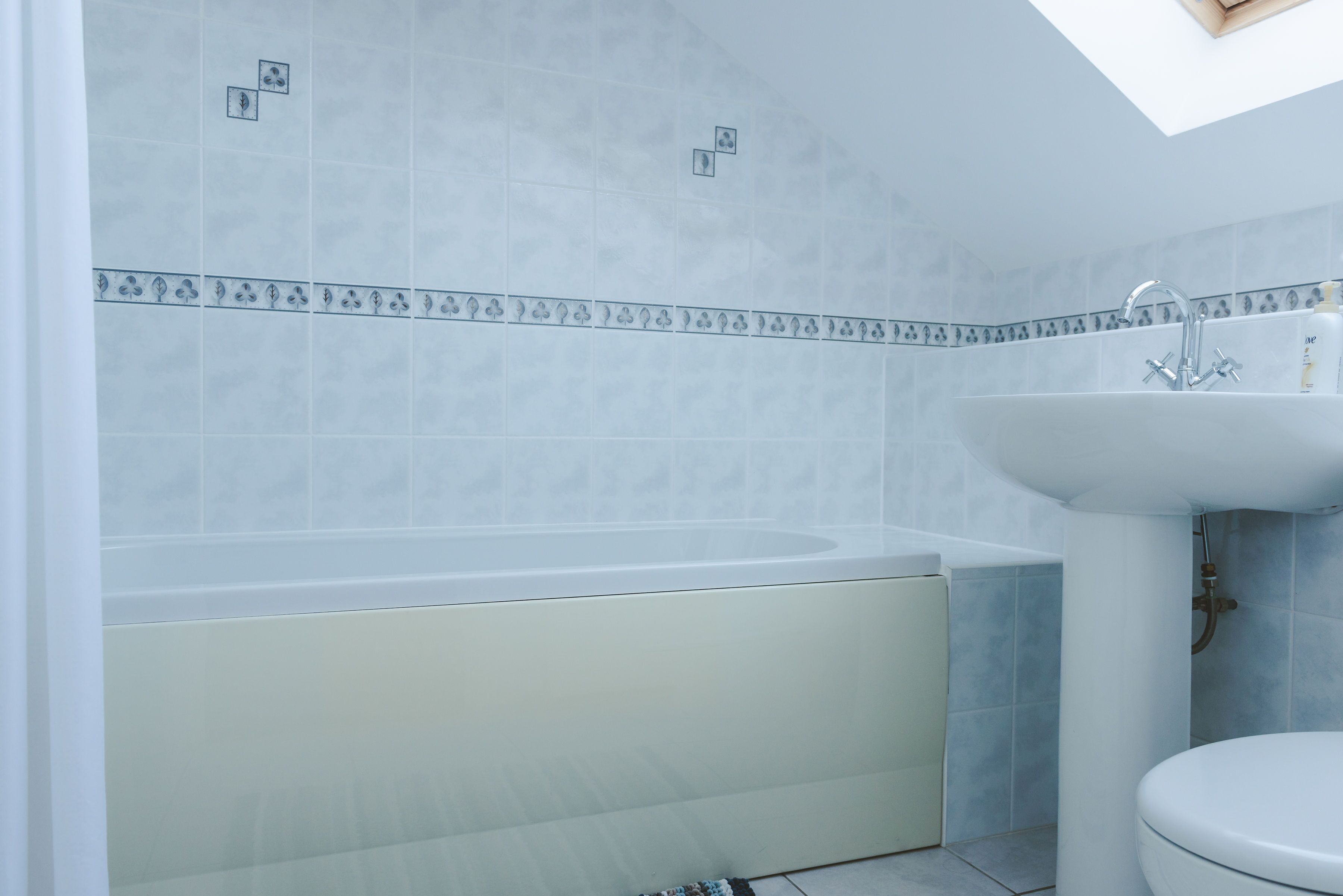 Un baño con bañera, lavamanos e inodoro.