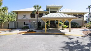 A two-story building with a sign reading "Shipyard Beach Club". - Sunset Rentals | Evian 170 (Hilton Head Island)