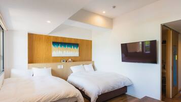 A modern hotel room with two beds, a wooden headboard, a flat-screen TV, and a wooden table.