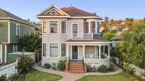 A two-story Victorian-style house with a wrap-around porch, a balcony on the second floor, and a brick entryway. - The Arabella House - Charmed Victorian in Historic Downtown Ventura (Ventura)