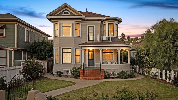 A two-story house with a balcony, a front porch, and a stone wall. - The Arabella House - Charmed Victorian in Historic Downtown Ventura (Ventura)