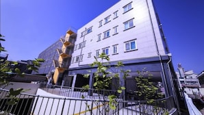 A modern building with multiple floors, balconies, and a clear sky. - Daecheon 323 Condo (Boryeong)
