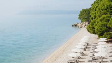 On the beach, beach cabanas, sun-loungers, beach umbrellas