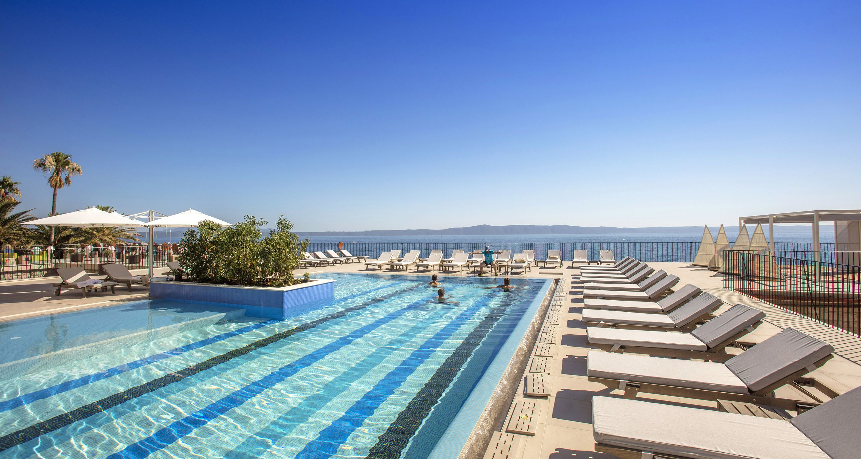 seasonal outdoor pool, pool umbrellas, pool loungers