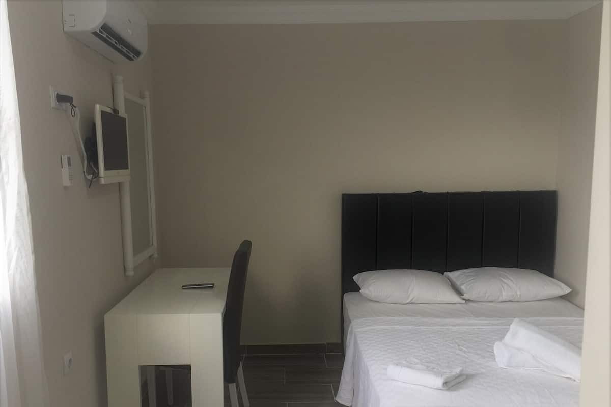 Premium bedding, desk, laptop workspace, blackout drapes