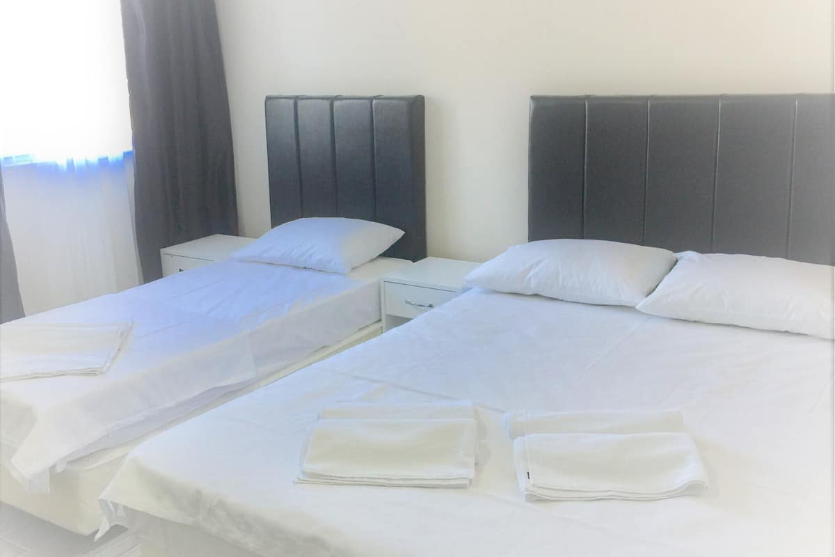 Premium bedding, desk, laptop workspace, blackout drapes