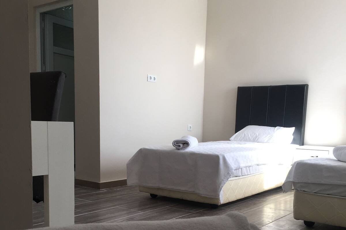 Premium bedding, desk, laptop workspace, blackout drapes