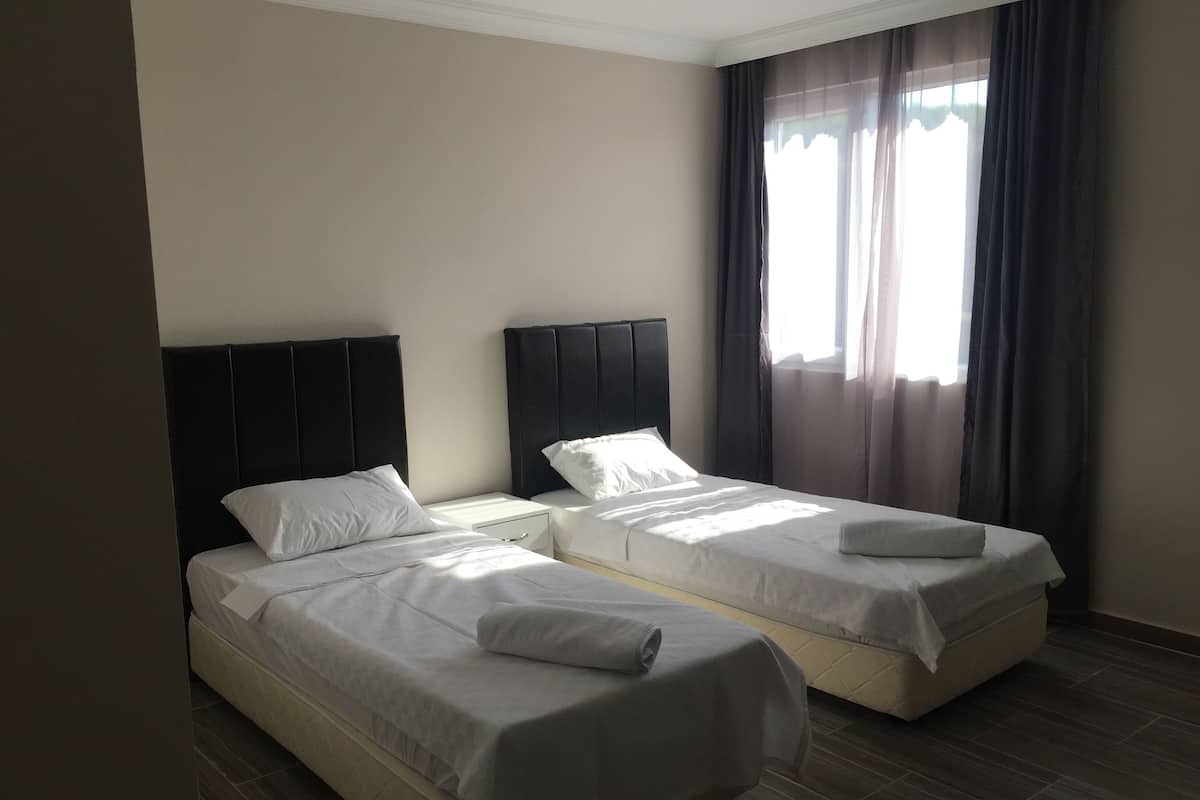 Premium bedding, desk, laptop workspace, blackout drapes