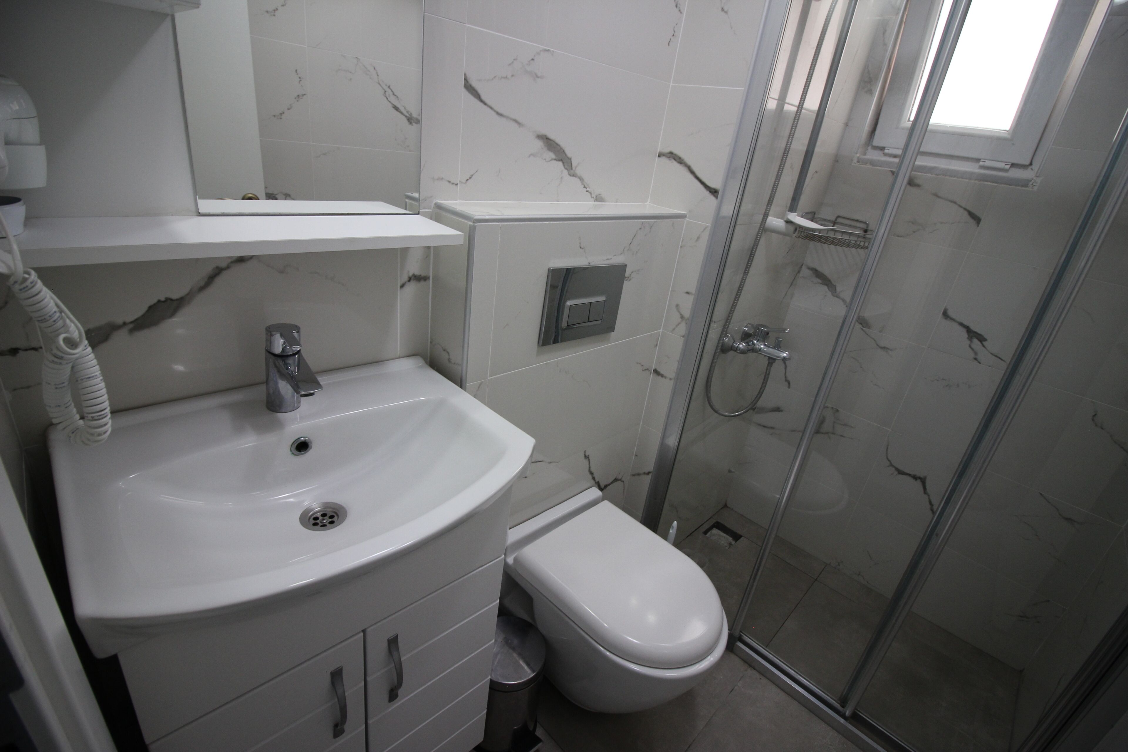 economy double room | bathroom | shower, hair dryer, towels, soap