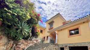 A two-story building with a stone staircase leading to a balcony. - Andalusian style villa with stunning views. PAX 6. FREE WIFI (Tarifa)