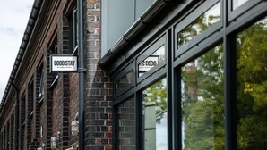 A building with brick walls and large windows. - Goodstay Apartments by Urban Space (Barry)