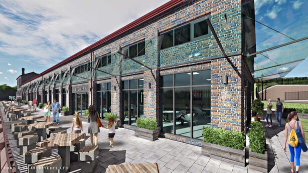 A modern building with a brick facade, large windows, and outdoor seating areas. - Goodstay Apartments by Urban Space (Barry)