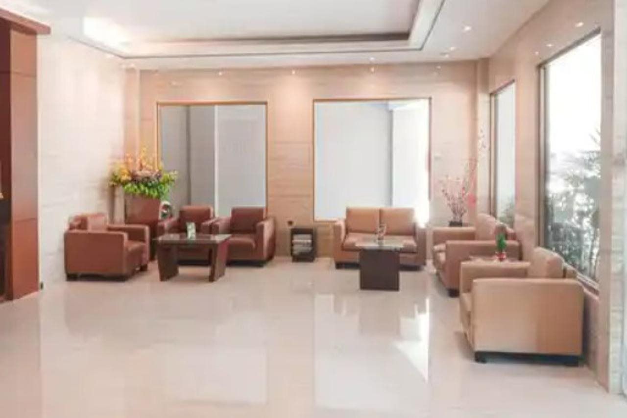 A modern living room with sofas, a coffee table, and a large window.