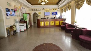 A hotel lobby with a reception desk, seating area, and a large chandelier. - Greentree Inn Baoding Sanfeng Road Agricultural Un (Baoding)