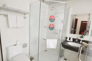 A modern bathroom with a glass-enclosed shower, a white toilet, a sink with a marble countertop, and a mirror above the sink. - Greentree Inn Baoding Sanfeng Road Agricultural Un (Baoding)