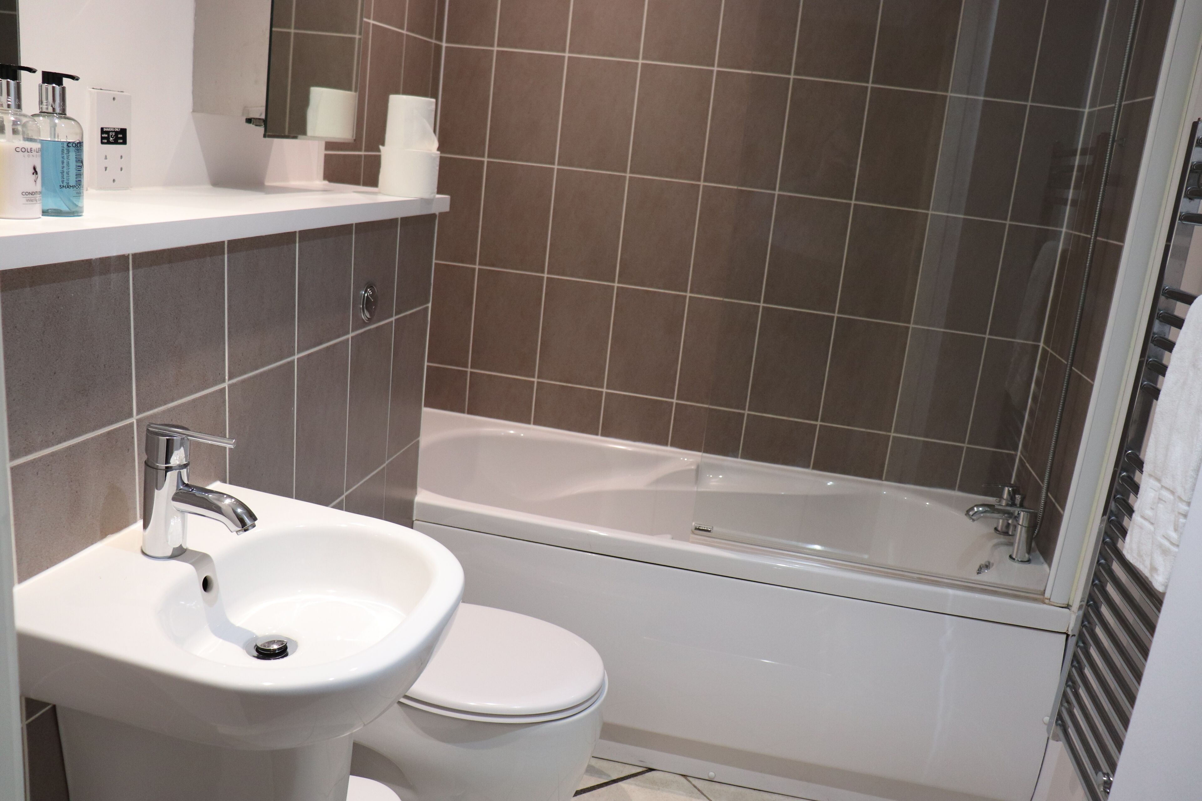 A bathroom with a sink, toilet, and bathtub.