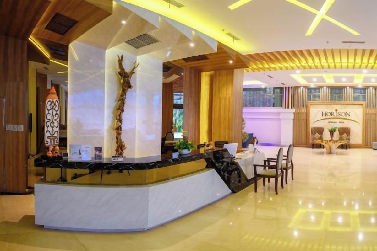 A reception area with a marble counter, wooden accents, and a 'Horizon' sign.