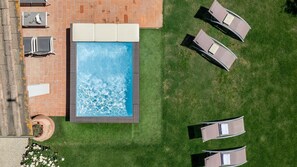 An aerial view of a swimming pool with lounge chairs and a brick patio. - Casetta Di Petriolo, Cerreto Guidi, Florence and Chianti (Cerreto Guidi)