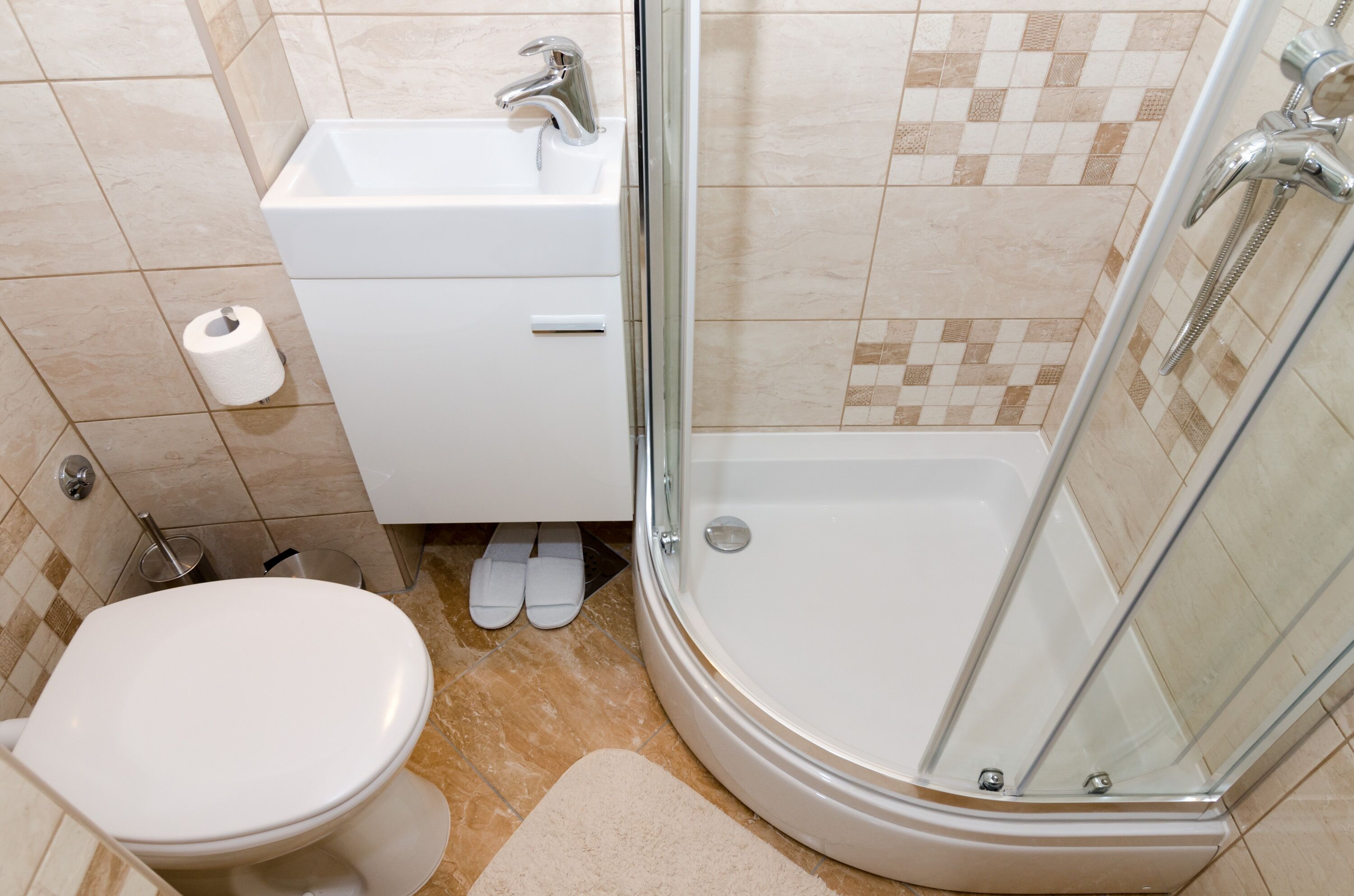 A bathroom with a toilet, sink, and shower.