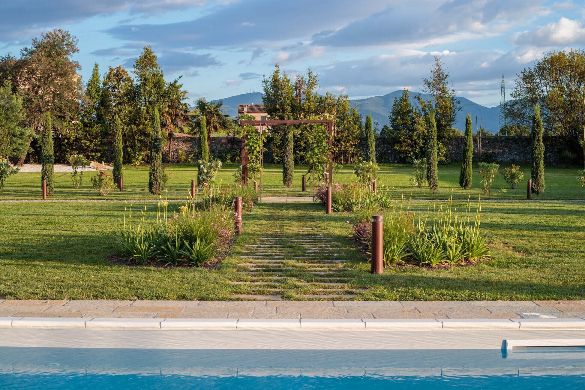 A poolside area with a clear view of a mountainous landscape in the background.