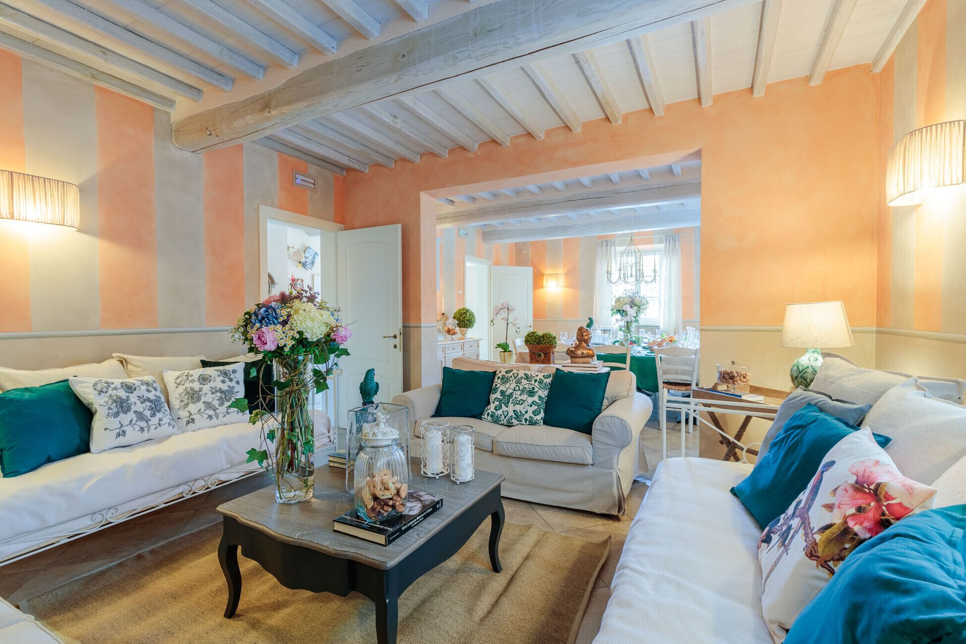 A cozy living room with two sofas, a coffee table, and a dining area with a table and chairs.