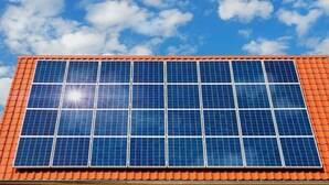 A building with a large solar panel array on the roof. - Kedros Precious Suites (Ilorin)