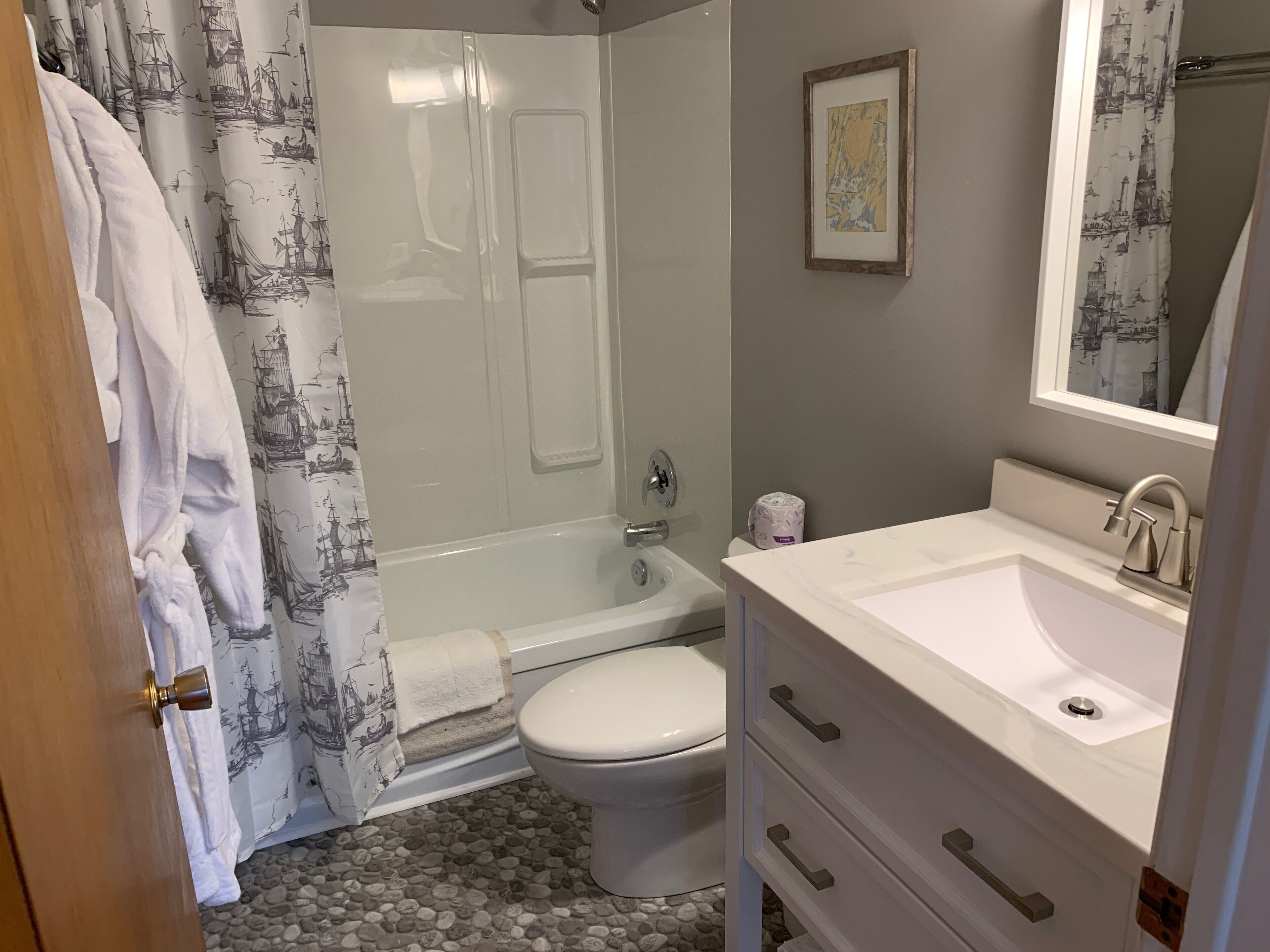 A bathroom with a bathtub, toilet, and sink.