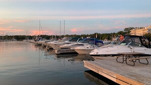 A marina with several boats docked at wooden piers. - Paradise Inn On The Beach (Saugeen Shores)