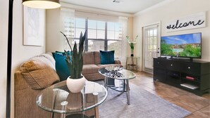 Ein modernes Wohnzimmer mit Sofa, Couchtisch und Fernsehschrank.