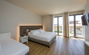 Minibar, desk, laptop workspace, bed sheets