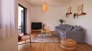 A living room with a sofa, a coffee table, a TV, and a patterned rug. - Phaedrus Living: Luxury Flat Protaras Sea View 9 (Paralimni)