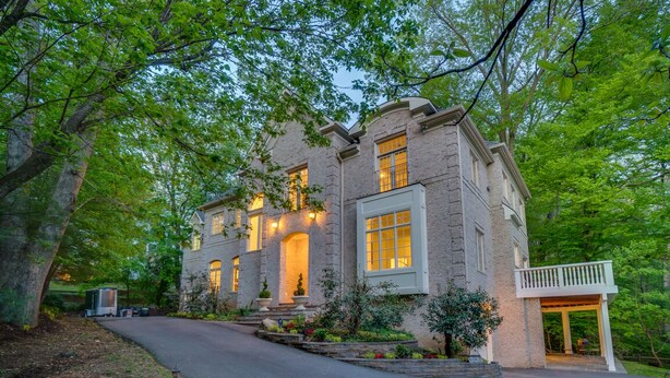 A two-story house with a brick exterior, a covered front porch, and a driveway leading to the entrance. - Wedding Venue - Maison D'artagnan on Pimmit Run - Great for Extended Stays (McLean)
