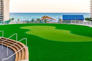 A golf course with a putting green, a clubhouse, and a view of the ocean. - Welcome to your fabulous beach get-away - a guest favorite with Gulf Views! (Panama City Beach)