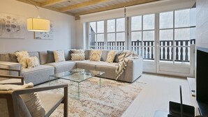 A living room with a sectional sofa, a glass coffee table, and a television. - Luderna - Casa Val de Ruda IV des Artiguetes (Baqueira)