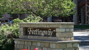 A stone sign with the name 'Ferringway' in a landscaped area with red flowers. - Durango Treehouse | Mountain Views | Hot Tub (Durango)