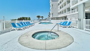 A pool area with blue lounge chairs and a hot tub. - PierWatch I 101 | Oceanfront Six Bedroom Condo (North Myrtle Beach)