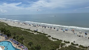 A beach with a swimming pool, umbrellas, and lounge chairs. - Ocean Front Resort in North Myrtle Beach,  Sleeps 6, Directly on the Beach! (North Myrtle Beach)