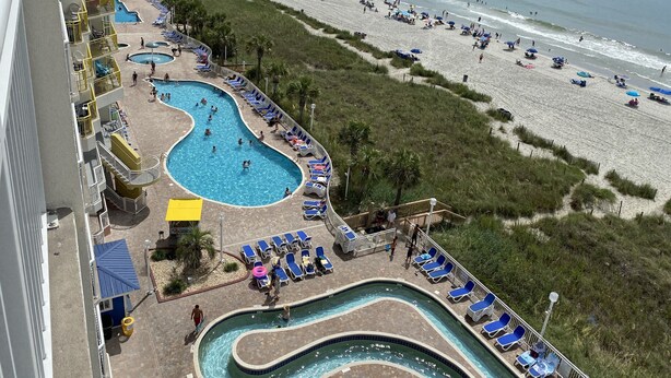 A resort with a swimming pool, beach, and ocean view. - Ocean Front Resort in North Myrtle Beach,  Sleeps 6, Directly on the Beach! (North Myrtle Beach)