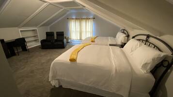 Relax in a cozy retreat with a large bed and comfortable seating area.