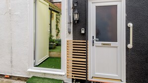 A white door with a nameplate reading "HODGES" and a white-framed window.