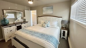 A bedroom with a bed, dresser, bedside tables, and a ceiling light. - Edgewater #4 Moose (Polson)