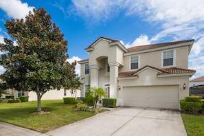 A two-story house with a white facade, a red-tiled roof, and a garage. - The Windsor Hills Resort by Florida Star Vacations (Kissimmee)