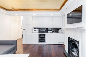 Apartment, 2 Bedrooms | Living area | Flat-screen TV, heated floors