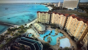 A resort with multiple buildings, a beachfront, and a pool area. - 5 Star Aruba Resort Christmas week! (Noord)
