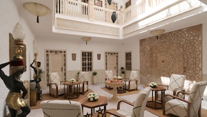 A spacious interior with high ceilings, a balcony, and traditional decor. - Riad Mareme & Spa (Marrakech)