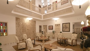 A spacious lobby with a high ceiling, ornate wall decorations, multiple seating areas, and a central fountain. - Riad Mareme & Spa (Marrakech)